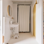 草加市の中古マンションのリノベーション後の洗面台とトイレのドア